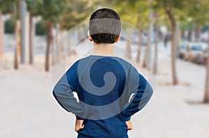 kid wearing blue shirt standing