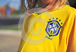 Kid wearing football shirt of Brasil national team