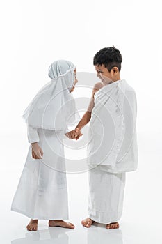 Kid wearing muslim ihram clothes and dress