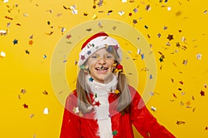 Kid wearing Santa costume throwing confetti