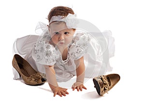 Kid in white dress crawling