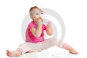 Kid wiping cleaning nose with tissue