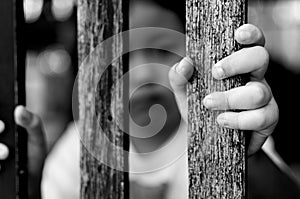 Kid with wood fence, feeling no freedom, black and white photography