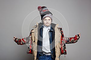 Kid wore all his clothes. Funny Boy in winter outerwear