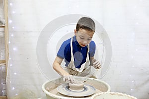 Kid working at pottery wheel