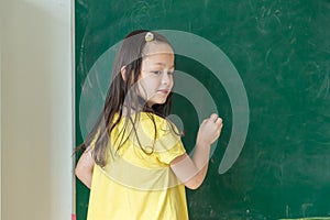 Kid write on chalk board. Back to school. Schoolchild in class. Happy kid writing green blackboard