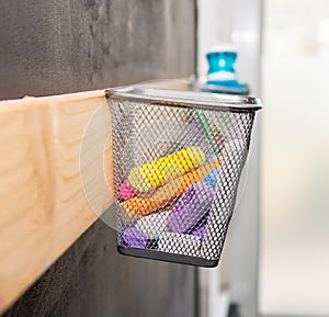 Kiddies play chalks stowed in a mesh basket