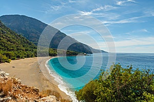 Kidrak beach with turquoise water near Oludeniz town on the coast of Mugla region in Turkey on summer day