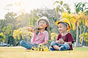 The kids acting as are engineer in the park. the concpet of the education, intelligence playful and future.