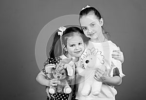 Kids adorable cute girls play with soft toys. Happy childhood. Child care. Sisters or best friends play. Sweet childhood