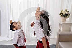 Kids against each other eating indonesian cracker on independence day