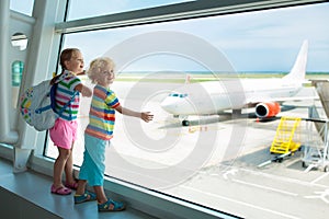 Kids travel and fly. Child at airplane in airport