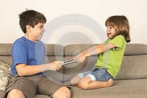 Kids arguing for playing with a digital tablet