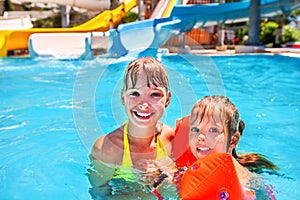 Kids with armbands in swimming pool