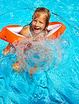 Kids with armbands in swimming pool.