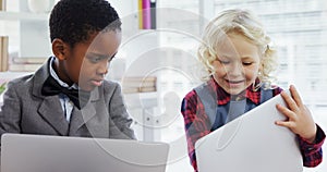 Kids as business executives discussing over laptop 4k