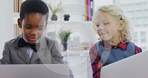 Kids as business executives discussing over laptop 4k