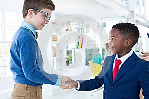 Kids as business executives shaking hands