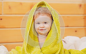 Kids baby cover head under towel after bath, portrait, close up head of cute child.