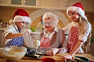 Kids baking cookies with grandmother on xmas