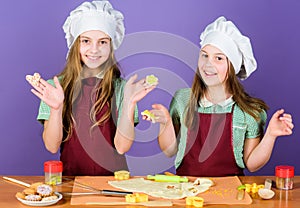 Kids baking cookies together. Kids aprons and chef hats cooking. Family recipe. Culinary education. Mothers day. Baking