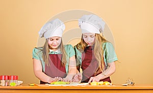 Kids baking cookies together. Kids aprons and chef hats cooking. Homemade cookies best. Family recipe. Cooking skill