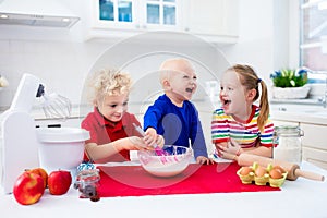 Kids baking a pie in white kitchen