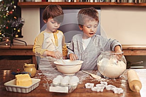Kids, baking and playing in kitchen with flour, home and bonding with ingredients for dessert cake. Children, mixing and