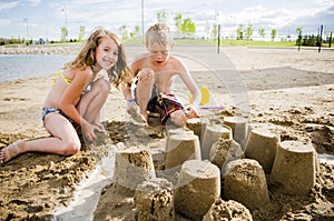 Kids on a beach with sand castle