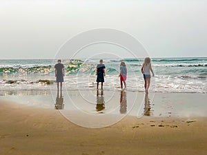 Kids at beach watching waves