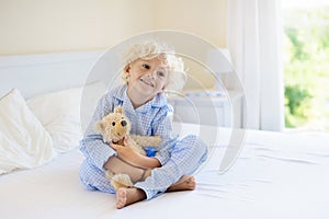 Kids in bed. Children in pajamas. Family bedroom.