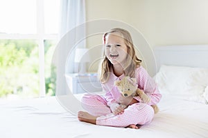 Kids in bed. Children in pajamas. Family bedroom.