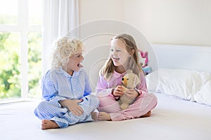 Kids in bed. Children in pajamas. Family bedroom