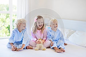 Kids in bed. Children in pajamas. Family bedroom