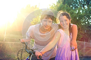 Kids with bicycle at sunset