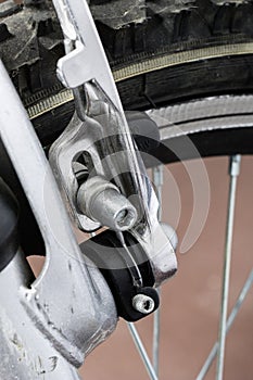 Kids bike. Shock absorber, brake, wheel shown close up.