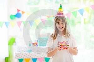 Kids birthday party. Child opening present