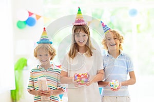 Kids birthday party. Child opening present