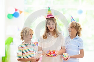 Kids birthday party. Child opening present