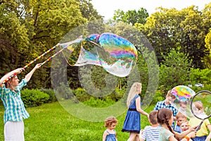 Kids birthday party at summer park with bubbles