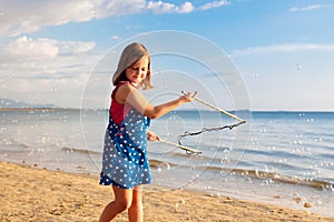 Kids blow bubble at beach. Child with bubbles