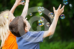 Kids blowing bubbles photo