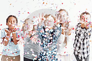 Kids blowing confetti