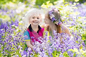 Kids with bluebell flowers, garden tools