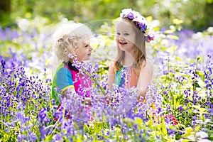 Kids with bluebell flowers, garden tools