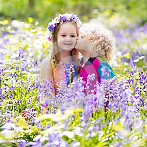 Kids with bluebell flowers, garden tools