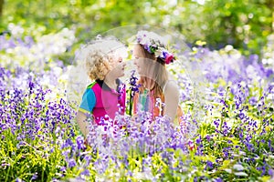 Kids with bluebell flowers, garden tools