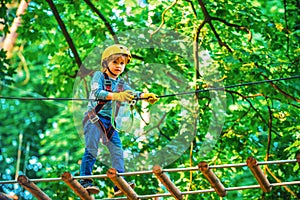 Kids boy adventure and travel. Adventure climbing high wire park. Early childhood development. Cute child in climbing