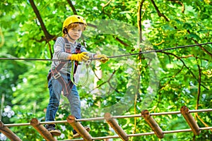 Kids boy adventure and travel. Adventure climbing high wire park. Early childhood development. Cute child in climbing