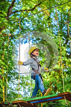 Kids boy adventure and travel. High ropes walk. Playground. Hike and kids concept. Climber child on training. Cute